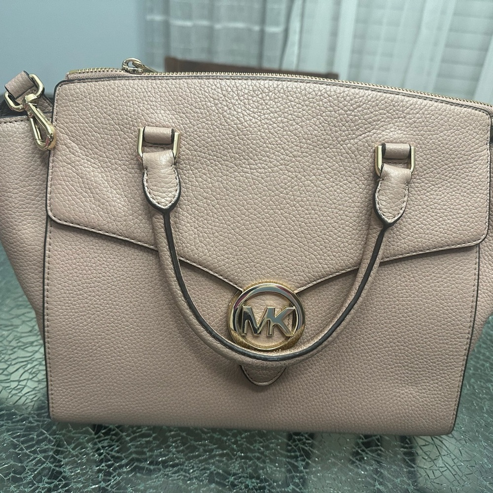Michael Kors purse in a taupe-pink colored purse.